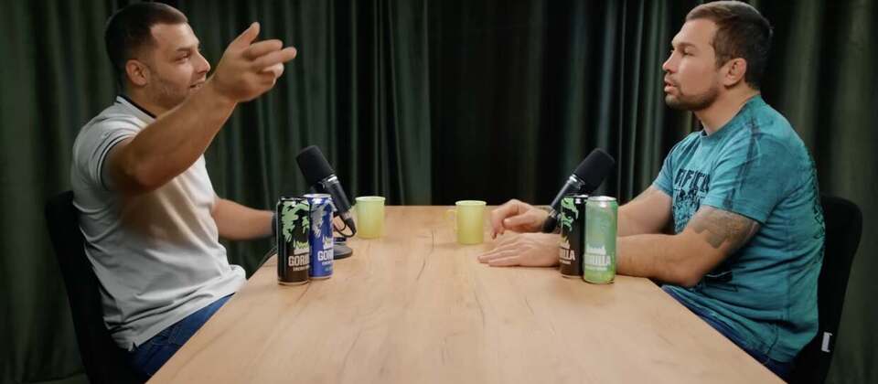 Two guests recording at the studio table